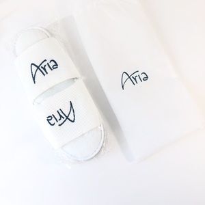 Aria hotel house slippers white travel dust bag